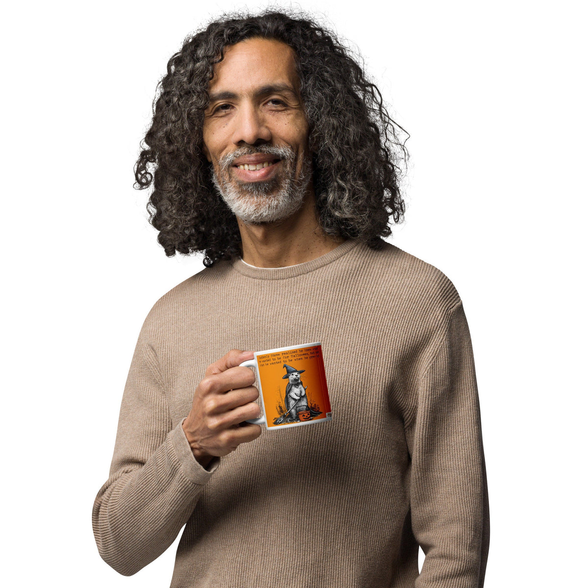 Man smiling while holding the Halloween otter mug