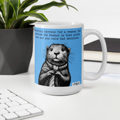 Bad Decisions otter mug, 15 oz, on a desk with a plant and books