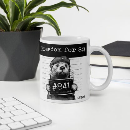 Otter 841 mug, 11 oz, on a desk with a plant and books: Freedom for 841
