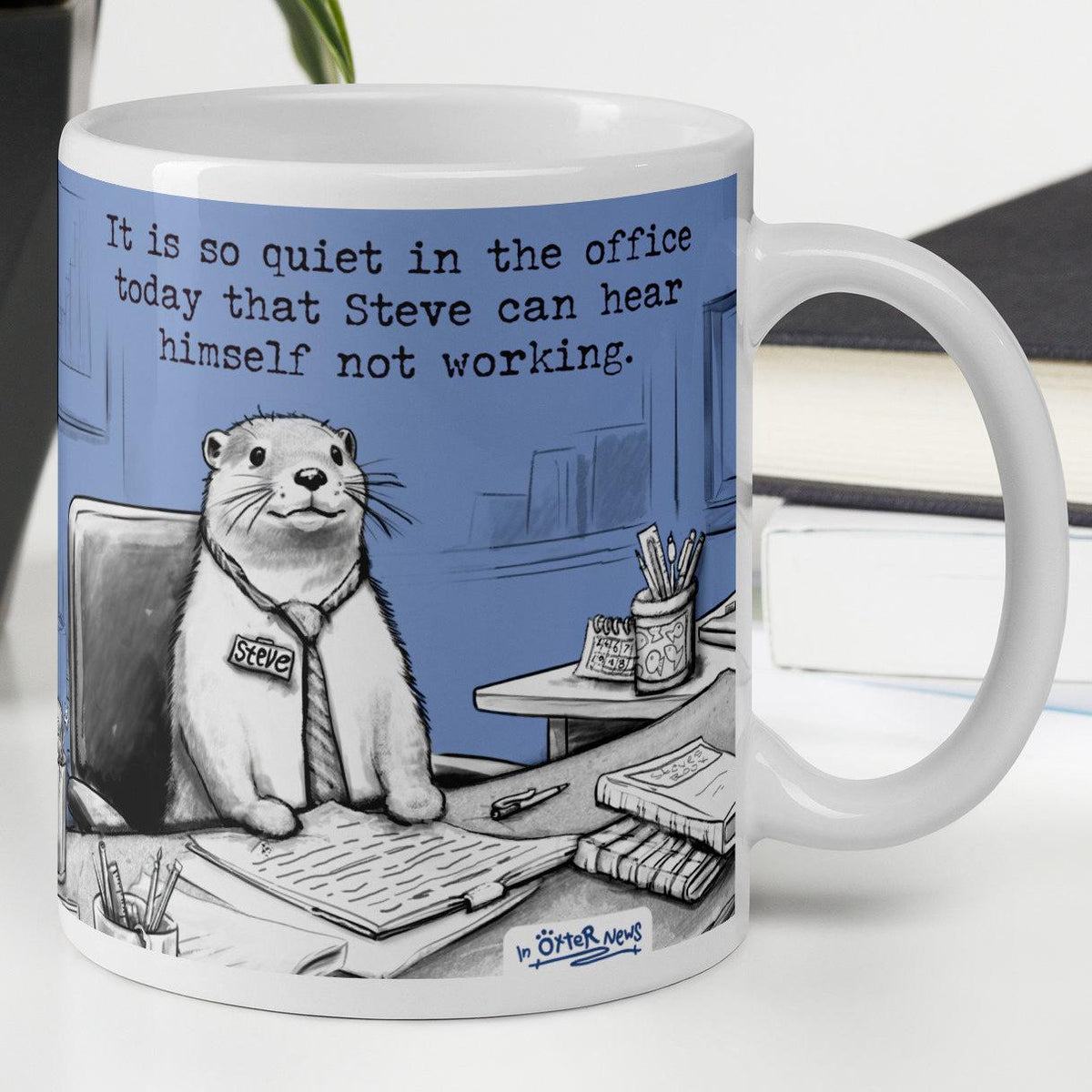 Quiet, Steve Is Working otter mug, 11 oz, with a plant and books: Steve at his desk
