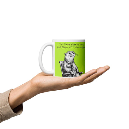 Hand holding the Shenanigans otter mug