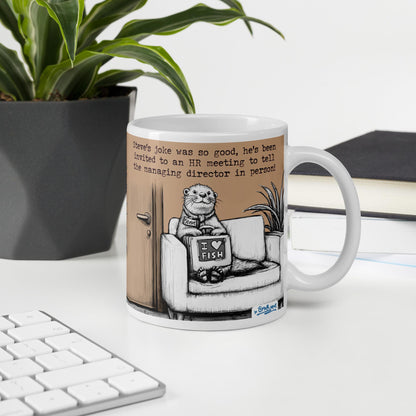 The Joke mug on a desk next to a keyboard